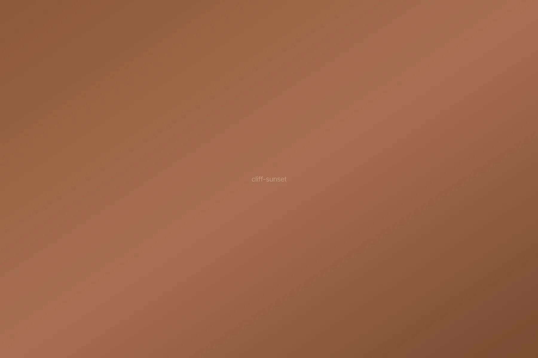 Sea cliffs silhouetted against orange sunset